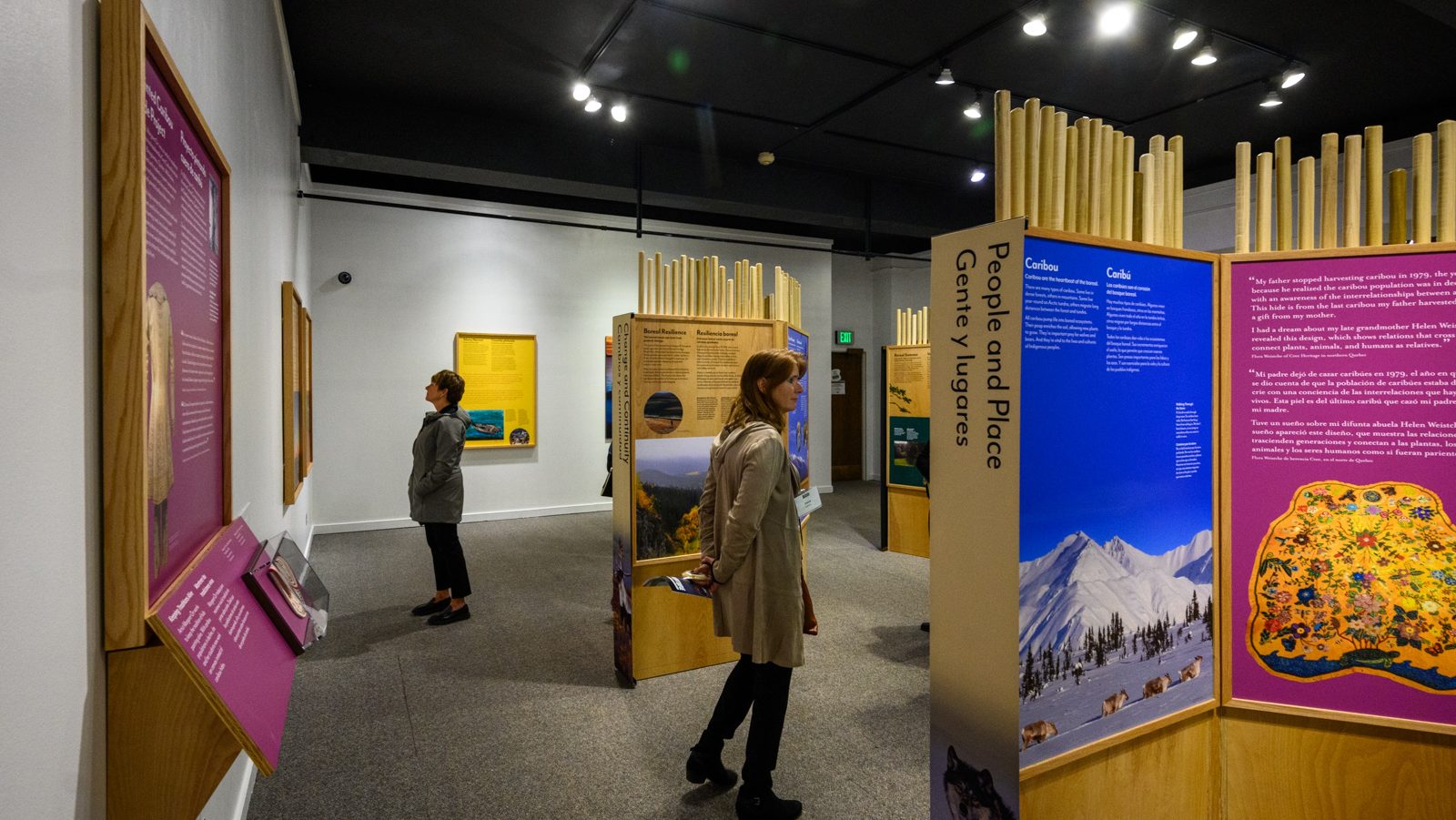 A visitor looks at Knowing Nature panels titled "People and Place."