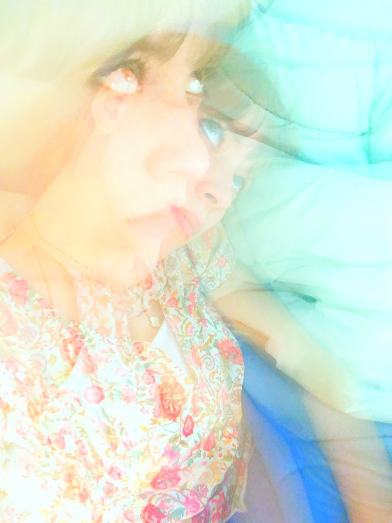 Dream-like overlaid photograph of Emily looking above and laying down.